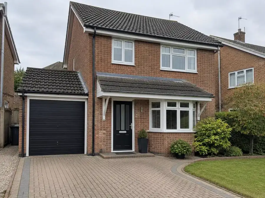 Black gutters and downpipe on a modern brick house in Dartford